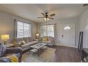 Spacious living room with hardwood floors, comfortable seating and large windows at 2701 W Cordelia St, Tampa, FL 33607