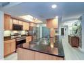 Modern kitchen with large island and granite countertops at 36750 Us Highway 19 N # 20-205, Palm Harbor, FL 34684