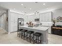Spacious kitchen with island and white cabinets at 4719 Avila Lakes Dr, Wimauma, FL 33598
