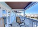 Private balcony with table and chairs overlooking the water at 5176 Se Salmon Se Dr # D, St Petersburg, FL 33705