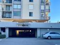 Condo building parking garage entrance with a car parked outside at 6104 Palma Del Mar S Blvd # 404, St Petersburg, FL 33715