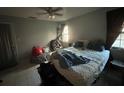 Main bedroom with a bed and window at 6947 Bottle Brush Dr, Port Richey, FL 34668