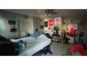 Bedroom with bed, desk and eclectic decor at 6947 Bottle Brush Dr, Port Richey, FL 34668