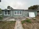 Rear view of house, showing patio and yard at 6947 Bottle Brush Dr, Port Richey, FL 34668