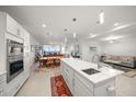 Open concept kitchen with island, stainless steel appliances, and water views at 920 N Osceola Ave # 702, Clearwater, FL 33755