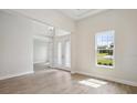 Spacious living room with wood-look floors and a view at 10195 Meadowrun Dr, Lithia, FL 33547