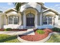 Elegant entryway with double doors and decorative columns at 10338 Meadow Crossing Dr, Tampa, FL 33647