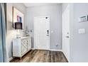 Entryway with a white cabinet, lamp, and coat hooks at 10601 Shady Falls Ct, Riverview, FL 33578