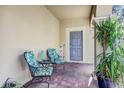 Inviting covered front porch with chairs, table, and decorations at 10601 Shady Falls Ct, Riverview, FL 33578