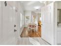 Bright and airy entryway with hardwood floors and view to dining area at 10883 Dragonwood Dr, Tampa, FL 33647