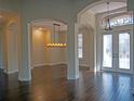 Spacious living area with hardwood floors and elegant chandelier at 1109 Toscano Dr, Trinity, FL 34655