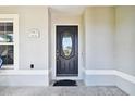 Dark-colored front door with glass panels and a welcome mat at 11411 Turtle Dove Pl, New Port Richey, FL 34654