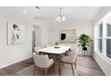 Bright dining room with hardwood floors and modern light fixture at 12332 Harris Hawk Rd, Weeki Wachee, FL 34614