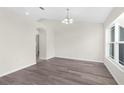 Spacious dining area with hardwood floors and large window at 12332 Harris Hawk Rd, Weeki Wachee, FL 34614