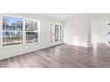 Light and airy entryway with wood-look floors and glass door at 12332 Harris Hawk Rd, Weeki Wachee, FL 34614