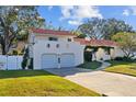 Two-story house with a two-car garage and a nicely landscaped yard at 14157 Feather Sound Dr, Clearwater, FL 33762