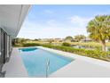 Relaxing rectangular pool with a view of a canal and neighborhood at 2024 N Pebble Beach Blvd, Sun City Center, FL 33573