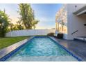 Relaxing rectangular pool with blue tile accents at 2246 Fiesta Dr, Sarasota, FL 34231