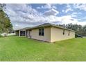 Back of house with screened patio and grassy yard at 2821 Holly Bluff Ct, Plant City, FL 33566