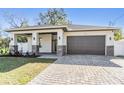 Modern home exterior with a two-car garage and attractive landscaping at 3326 W Heiter St, Tampa, FL 33607