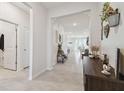 Bright and airy entryway with tile flooring, access to other rooms, and decor at 35980 Morse Willow Ct, Zephyrhills, FL 33541