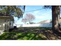 Large grassy backyard with a white vinyl fence at 36150 Pine Bluff Loop, Dade City, FL 33525