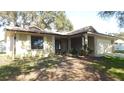 Newly renovated house with a covered porch and manicured lawn at 36150 Pine Bluff Loop, Dade City, FL 33525