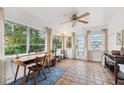 Sunroom with terracotta tile floor, wood desk, and large windows offering natural light at 5107 27Th S Ave, Gulfport, FL 33707