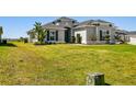 House exterior showcasing landscaping and a large front yard at 5226 Lake Venice Dr, Wimauma, FL 33598