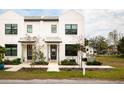 Modern white duplex with gray doors and walkway at 5980 Central Ave, New Port Richey, FL 34653