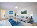 Living room with light beige sofa and blue accents at 721 1St Ct, Palm Harbor, FL 34684