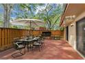 Outdoor patio with a staged dining set and grill, perfect for entertaining at 721 1St Ct, Palm Harbor, FL 34684