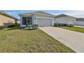 One-story home with a two-car garage and a well-maintained lawn at 727 Winterside Dr, Apollo Beach, FL 33572