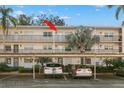 Condo building exterior showing building entrance and parking at 831 Maple Ct # 303, Dunedin, FL 34698