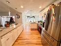 Modern kitchen with white cabinets, granite countertops, and stainless steel appliances at 8616 Pinafore Dr, New Port Richey, FL 34653
