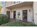 Condo entry with patio furniture and a charming, secluded feel at 1401 Cordova Grn, Seminole, FL 33777