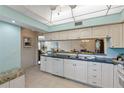 Bright kitchen with white cabinets, granite counters, and a breakfast nook at 1401 Cordova Grn, Seminole, FL 33777