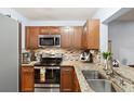 Kitchen with granite countertops, stainless steel appliances, and wood cabinets at 1449 Highland Ridge Cir, Brandon, FL 33510