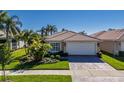 Front view of a single-story house with a white garage door at 15731 Crystal Waters Dr, Wimauma, FL 33598