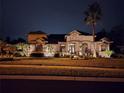 Night view of a two story house with lights at 1655 Canopy Oaks Blvd, Palm Harbor, FL 34683