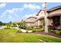 House exterior with a nicely landscaped front yard at 1655 Canopy Oaks Blvd, Palm Harbor, FL 34683