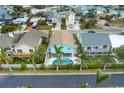 Aerial view of a teal house with a pool in a neighborhood at 17706 1St E St, Redington Shores, FL 33708