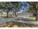 Spacious home with a three-car garage and a long driveway at 456 Diamond Dr, Spring Hill, FL 34609