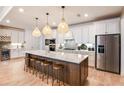 Modern kitchen with white cabinets, large island, and stainless steel appliances at 6136 Jensen View Ave, Apollo Beach, FL 33572