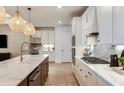 Modern kitchen with white cabinets, large island, and stainless steel appliances at 6136 Jensen View Ave, Apollo Beach, FL 33572