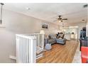 Living room with gray sectional sofa and laminate wood floors at 7029 Oakwood Dr, New Port Richey, FL 34652