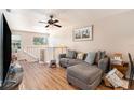 Living room with gray sectional and access to the kitchen at 7029 Oakwood Dr, New Port Richey, FL 34652