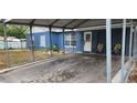 Covered carport with space for one vehicle and chairs at 8106 N Rome Ave, Tampa, FL 33604