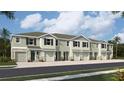 Modern 3-story townhome with attached garage and neutral color palette at 11381 Crescent Deer Dr, Land O Lakes, FL 34638
