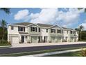 New townhome community with multiple units, featuring attached garages and neutral color palettes at 11389 Crescent Deer Dr, Land O Lakes, FL 34638